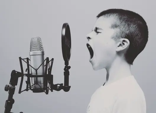 boy yelling at a microphone